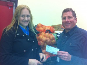 Julie Carpenter of Whatcom Women's Network presents a $500 check to Mike Cohen, director of the Bellingham Food Bank.