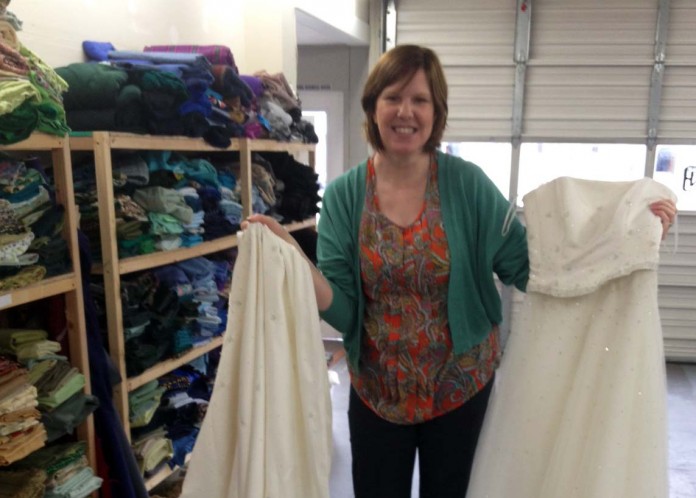 Woman poses with wedding dresses for Ragfinery's second Upcycle Challenge.