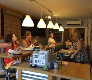 Linda Melim chats with her regulars while creating salads, sandwiches and soups. The daily menu is posted on butcher paper and on the restaurant’s Facebook page.