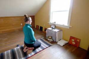 Summer takes time for her personal yoga practice in her home practice room.