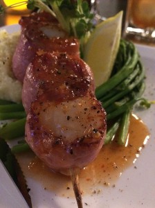 Tender, prosciutto wrapped scallops are served with a sweet chili glaze.