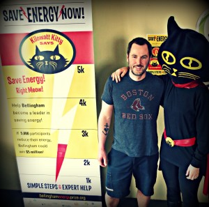 Bellingham resident, Derek, is being congratulated by Kilowatt Kitty after being drawn as the first winner of "Free Utilities for a Month" for connecting his utilities in the Energy Center at BellighamEnergyPrize.org. Photo courtesy: Sustainable Connections.