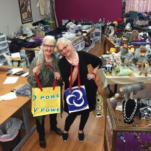 Renee Sherrer & Molly Chambers model their fun, upcycled bags made from old vinyl banners. Photo courtesy: Social Fabric.