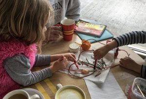 Children conduct electrical current with cutie oranges- enough to power a small clock. Photo credit: Dondi Tondro-Smith.