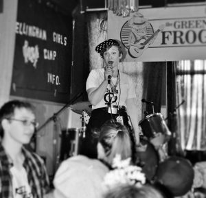 Morgan Paris Lanza sings on stage for a live performance at the Green Frog in Bellingham. The Bellingham Girls Rock Club has performed here in the past. Photo credit: Alycia Hendrickson.