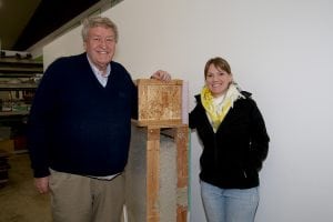 John Moon, Executive Director, and Alyssa Carpenter, Women Build leader, stand next to the insulating model that helps keep Habitat for Humanity homes energy efficient. Photo credit: Theresa Golden.
