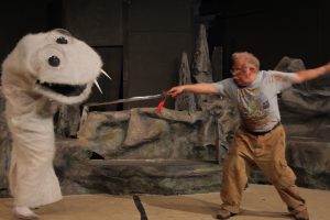 Sandy Brewer faces off with a sock puppet in “Kill Me Now” written by Mathew Thomas Williamson. The sock puppet costume was made in 2013 season by Shu-Ling Hergenhahn-Zhau. Photo credit: Tad Beavers.