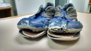 A worn out pair of shoes gets exchanged for brand new ones during Blue Skies for Children's Shoe Give Program. Photo courtesy: Blue Skies for Children.