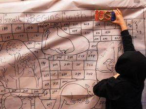 A fourth grader exudes pride for his participation with the community mural. Photo credit: Patricia Herlevi.