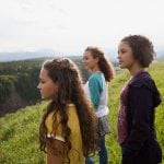 Teenage sisters looking at remote rural view
