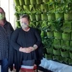 Christie-and-Shannon-stand-beside-the-growing-herb-wall2