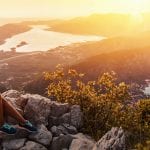 Happy couple watching the sunset in the mountains