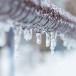 frozen icicles after rain on the pipe