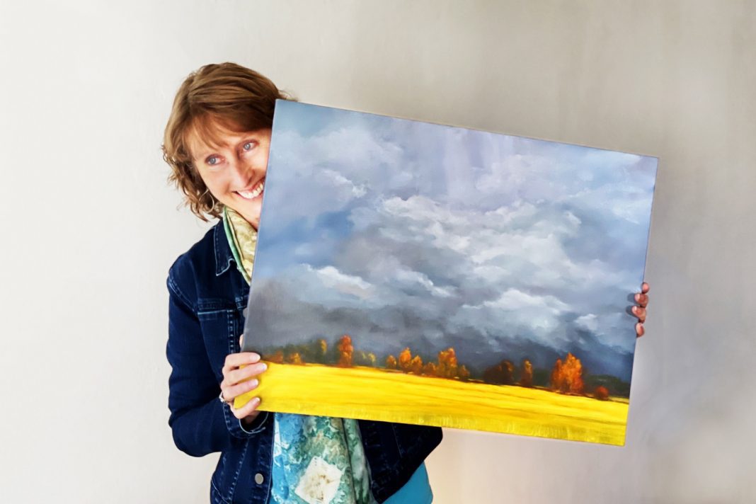 woman holding painting