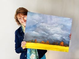 woman holding painting